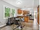 Eat-in kitchen features stainless steel appliances, natural wood cabinets and lots of natural light at 7317 Red Branch Ln, Charlotte, NC 28226