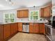 Modern kitchen with stone counters, wood cabinets and stainless steel appliances, creates a clean and functional culinary space at 7317 Red Branch Ln, Charlotte, NC 28226