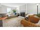 Comfortable living area featuring a brick fireplace, natural light, and stylish furniture, perfect for Gathering time and entertaining at 7317 Red Branch Ln, Charlotte, NC 28226