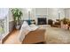 Cozy living room with a white brick fireplace, warm lighting, and comfortable seating, perfect for relaxation and gatherings at 7317 Red Branch Ln, Charlotte, NC 28226