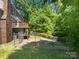 Large backyard with chain link fence, a deck, and mature trees perfect for outdoor activities and relaxation at 7737 Batavia Ln, Charlotte, NC 28213