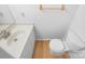 A half bathroom features a well-maintained toilet and vanity, offering functionality in a compact space at 7737 Batavia Ln, Charlotte, NC 28213