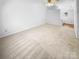 Spacious empty room with neutral carpet and ample natural light, offering a blank canvas for personalization at 7737 Batavia Ln, Charlotte, NC 28213