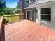 Spacious deck with wood railing and plenty of room for outdoor seating and entertaining with brick chimney at 7737 Batavia Ln, Charlotte, NC 28213