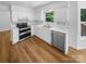 Clean, modern kitchen with stainless steel appliances, white cabinetry, and a stainless steel sink at 7737 Batavia Ln, Charlotte, NC 28213