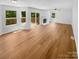 Bright and airy living room with hardwood floors, a ceiling fan, and access to an outdoor deck at 7737 Batavia Ln, Charlotte, NC 28213