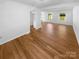 Sun-filled living room featuring hardwood floors and a neutral color palette at 7737 Batavia Ln, Charlotte, NC 28213