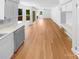 Bright living room featuring wood floors, a fireplace, and access to a deck, seamlessly connecting indoor and outdoor spaces at 7737 Batavia Ln, Charlotte, NC 28213