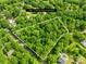 Aerial view of a 2.25 acre lot surrounded by mature trees in a residential area at 7949 Ritter Dr, Charlotte, NC 28270