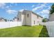 Backyard view, showcasing fenced yard with green grass at 826 Sinclair Dr, Monroe, NC 28112