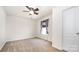 Bright bedroom featuring neutral walls, carpet, a ceiling fan, and a window with curtains at 826 Sinclair Dr, Monroe, NC 28112