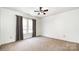 Simple bedroom with neutral carpet and walls with large windows and a ceiling fan at 826 Sinclair Dr, Monroe, NC 28112
