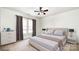 Calm bedroom with neutral walls, large windows, a ceiling fan, a bed, and nightstands at 826 Sinclair Dr, Monroe, NC 28112