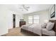 Bedroom with neutral walls, large windows, closet, a bed, a dresser, and ceiling fan at 826 Sinclair Dr, Monroe, NC 28112