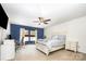 Comfortable bedroom features blue accent wall, desk, ceiling fan, window, and a full bed at 826 Sinclair Dr, Monroe, NC 28112