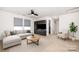 Cozy bonus room with a sofa, ceiling fan, two windows, carpet, and a stylish coffee table at 826 Sinclair Dr, Monroe, NC 28112