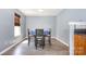 Bright dining area featuring hardwood floors, a blue wall, and a gray table and chairs at 826 Sinclair Dr, Monroe, NC 28112