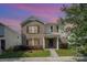 Two-story home featuring brick and siding, a front porch, black shutters, and a green lawn at 826 Sinclair Dr, Monroe, NC 28112