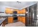 Kitchen features wood cabinets, mosaic backsplash, stainless steel appliances and hardwood floors at 826 Sinclair Dr, Monroe, NC 28112