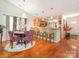 Open dining area with hardwood floors, modern lighting, and breakfast bar at 9348 Golden Pond Dr, Charlotte, NC 28269