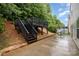 Backyard featuring a black wood deck, wood stairs, and grill at 9524 Eagle Feathers Dr, Charlotte, NC 28214