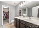 Ensuite bathroom features a double vanity with dark cabinets, a walk-in closet, and a linen closet at 9524 Eagle Feathers Dr, Charlotte, NC 28214