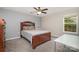 Bedroom showcasing a wooden bed frame, a ceiling fan, and natural lighting at 9524 Eagle Feathers Dr, Charlotte, NC 28214