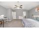 Primary bedroom featuring neutral paint, a ceiling fan, and an ensuite bathroom at 9524 Eagle Feathers Dr, Charlotte, NC 28214