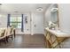 Inviting entryway featuring modern console table, light fixtures, wood flooring and blue-themed decor at 9524 Eagle Feathers Dr, Charlotte, NC 28214