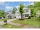 Suburban home featuring well-maintained lawn, a two-car garage, and a tree planted in the front yard at 9524 Eagle Feathers Dr, Charlotte, NC 28214