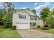 Charming two-story home with gray shutters, vinyl siding, manicured lawn and two-car garage at 9524 Eagle Feathers Dr, Charlotte, NC 28214