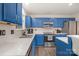 Updated kitchen featuring blue cabinets, stainless steel appliances, and bright, white countertops at 9524 Eagle Feathers Dr, Charlotte, NC 28214