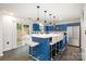 Spacious kitchen featuring a large center island, blue cabinets, pendant lights, and stainless steel appliances at 9524 Eagle Feathers Dr, Charlotte, NC 28214