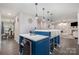Open kitchen with a breakfast bar featuring pendant lights, white counters, and a beverage refrigerator at 9524 Eagle Feathers Dr, Charlotte, NC 28214