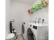 Bright laundry room with a washer, dryer, shelving, and neutral walls at 9524 Eagle Feathers Dr, Charlotte, NC 28214