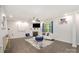 Bright living room offers recessed lights, a fireplace, modern furniture, and neutral paint at 9524 Eagle Feathers Dr, Charlotte, NC 28214