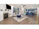 Open concept living room flowing into kitchen, featuring modern furniture and neutral paint at 9524 Eagle Feathers Dr, Charlotte, NC 28214