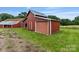 Exterior view of a red barn with a metal roof, complemented by a well-maintained green lawn at 956 Stony Point Rd, Kings Mountain, NC 28086
