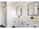 Bathroom featuring double sinks, modern black fixtures, white cabinets, and stylish black framed mirrors at 956 Stony Point Rd, Kings Mountain, NC 28086