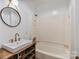 Bathroom featuring wood shelving, updated sink, modern fixtures, and shower with a bathtub at 956 Stony Point Rd, Kings Mountain, NC 28086