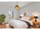 Bright bedroom with large bed, bedside tables, warm lamps, and windows looking out onto trees at 956 Stony Point Rd, Kings Mountain, NC 28086
