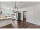 Eat-in kitchen with white cabinets, stainless steel refrigerator, and stylish pendant light at 956 Stony Point Rd, Kings Mountain, NC 28086