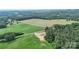This aerial view shows the location amongst lush trees and cornfields nearby at 977 Myers Mill Rd, Olin, NC 28660