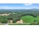 Panoramic aerial view showcasing a home nestled amongst lush greenery, rolling hills, and scenic farmland at 977 Myers Mill Rd, Olin, NC 28660