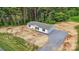Aerial view of the home showcasing its location, surrounding greenery, and gravel driveway at 977 Myers Mill Rd, Olin, NC 28660