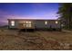 Rear exterior features small deck and vinyl siding; backyard awaiting personalization at 977 Myers Mill Rd, Olin, NC 28660