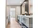 Modern bathroom with dual vanities, framed mirrors, and stylish fixtures over the laminate floor at 977 Myers Mill Rd, Olin, NC 28660