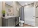 Bathroom with gray vanity, framed mirror, and shower-tub combo for a functional space at 977 Myers Mill Rd, Olin, NC 28660