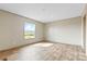 Spacious bedroom with laminate wood flooring and abundant natural light from the single window at 977 Myers Mill Rd, Olin, NC 28660