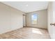 Bright bedroom with laminate wood flooring and abundant natural light from the single window at 977 Myers Mill Rd, Olin, NC 28660